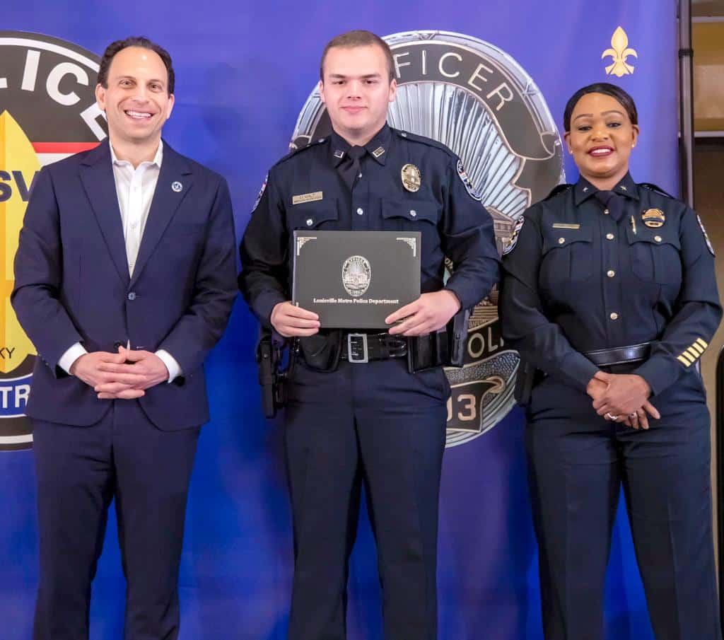 Nickolas Wilt, pictured appeared to show him at his swearing in ceremony alongside the police chief and Louisville Mayor Craig Greenberg.