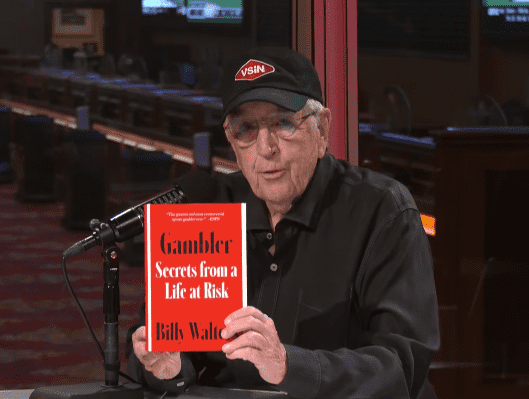 Brent Musburger holds up Billy Walters's autobiography in the unprecedented interview covering everything from his relationship with Phil Mickelson, his time in prison, details of his betting systems, ticking off Steve Wynn, and his potential pardon from President Trump (@VSiN/Youtube)
