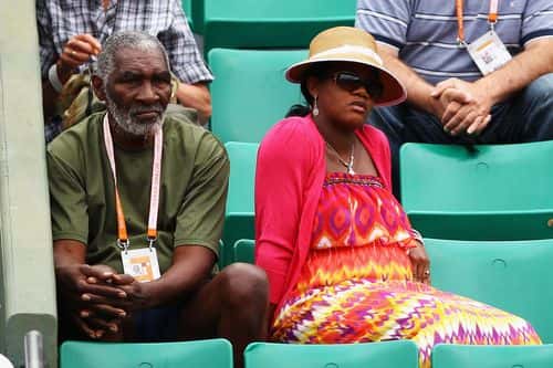 Richard Williams and his wife Lakeisha Graham watch the women's singles second round match between Agnieszka Radwanska of Poland and Venus Williams of USA during day four of the French Open at Roland Garros on May 30, 2012 in Paris, France. (Photo by Clive Brunskill/Getty Images)