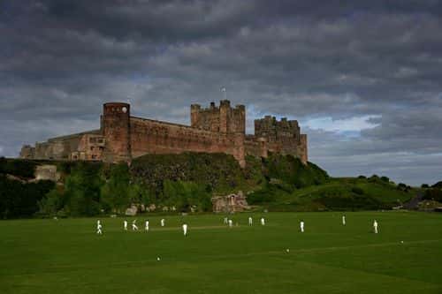 Cricketers from Bamburgh Castle Cricket Club play at the foot of Bamburgh Castle on July 13, 2008 in Bamburgh, England.