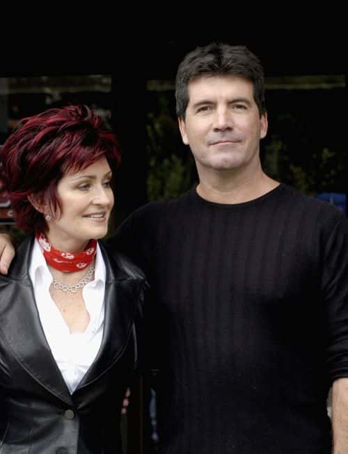 Sharon Osbourne and Simon Cowell pose for photos after auditioning hundreds of hopeful musicians for their new TV show 