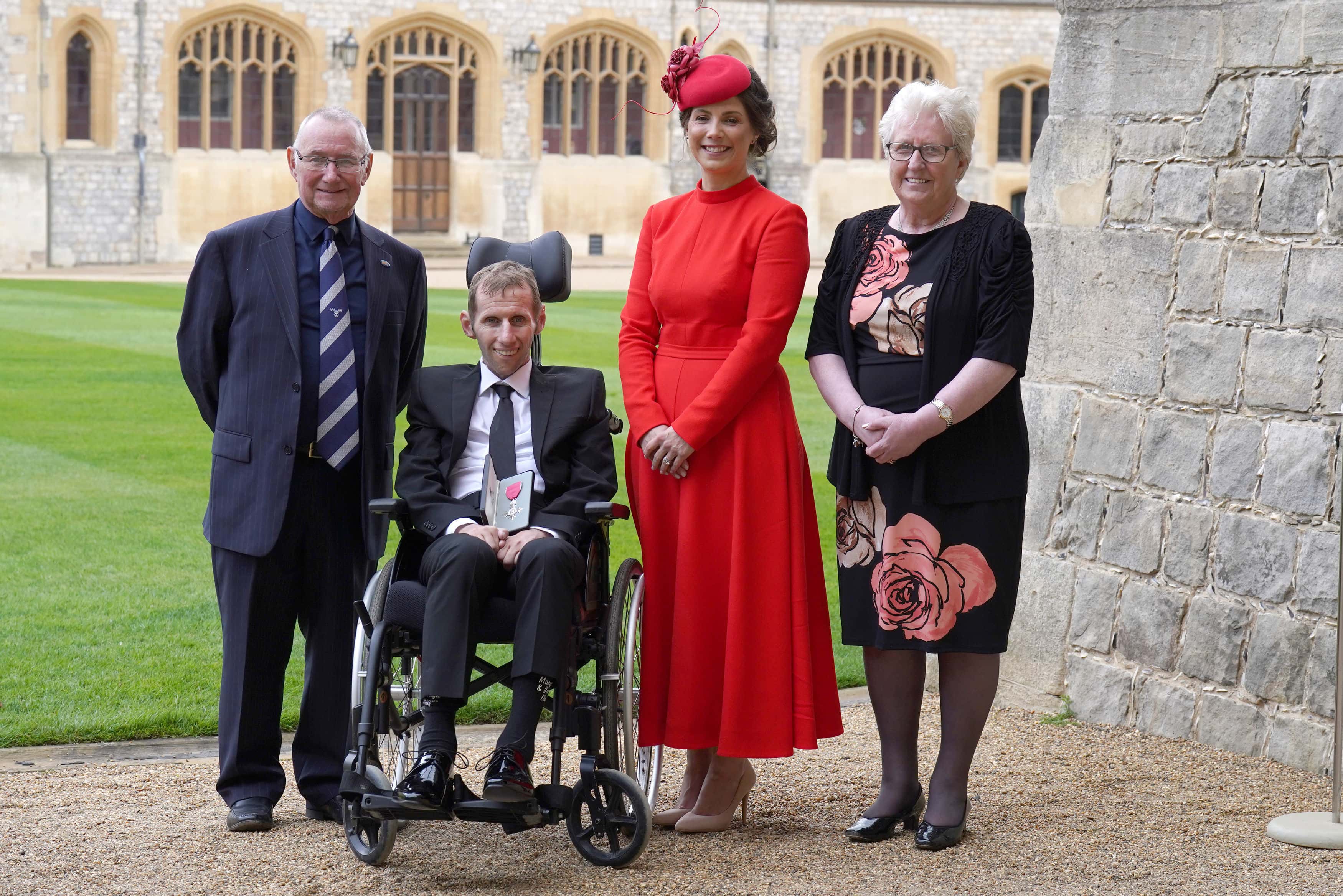 Robert Burrow (second from left) with (from left to right) father Geoff Burrow, wife Lindsey and mother Irene after he was made an MBE by the Princess Royal during an investiture ceremony at Windsor Castle on April 5, 2022 in Windsor, England.