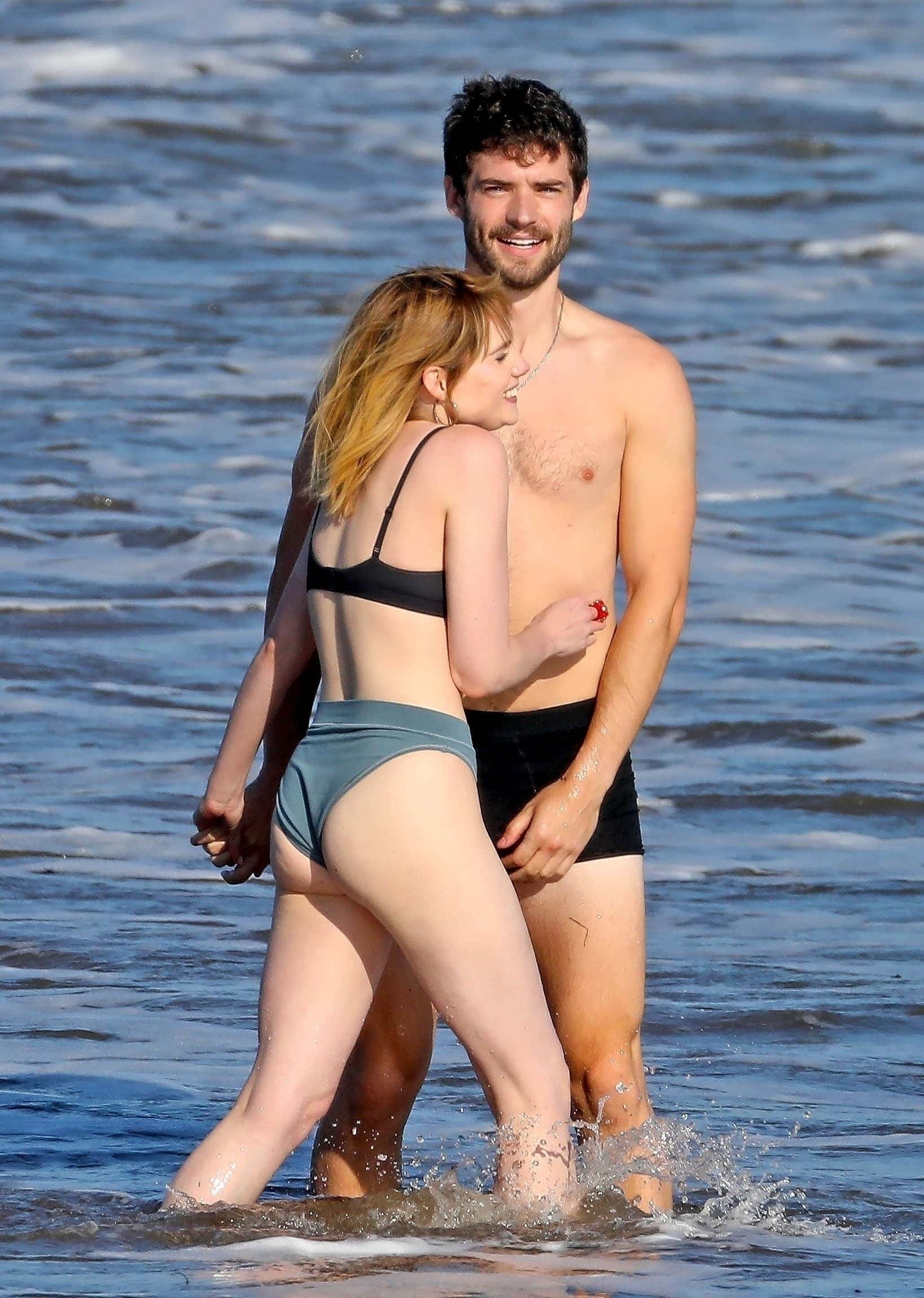 David Corenswet, the new Superman replacing Henry Cavill, sparks excitement on Twitter with photos showing him frolicking and passionately cuddling co-star Boynton in the surf (Backgrid)