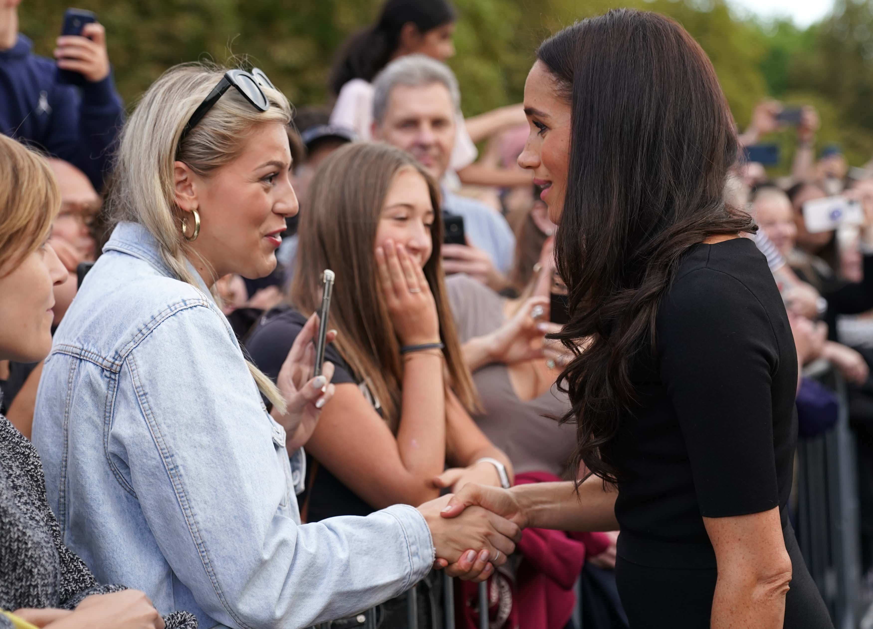 Meghan, Duchess of Sussex meet members of the public at Windsor Castle on September 10, 2022 in Windsor, England. Crowds have gathered and tributes left at the gates of Windsor Castle to Queen Elizabeth II, who died at Balmoral Castle on 8 September, 2022.