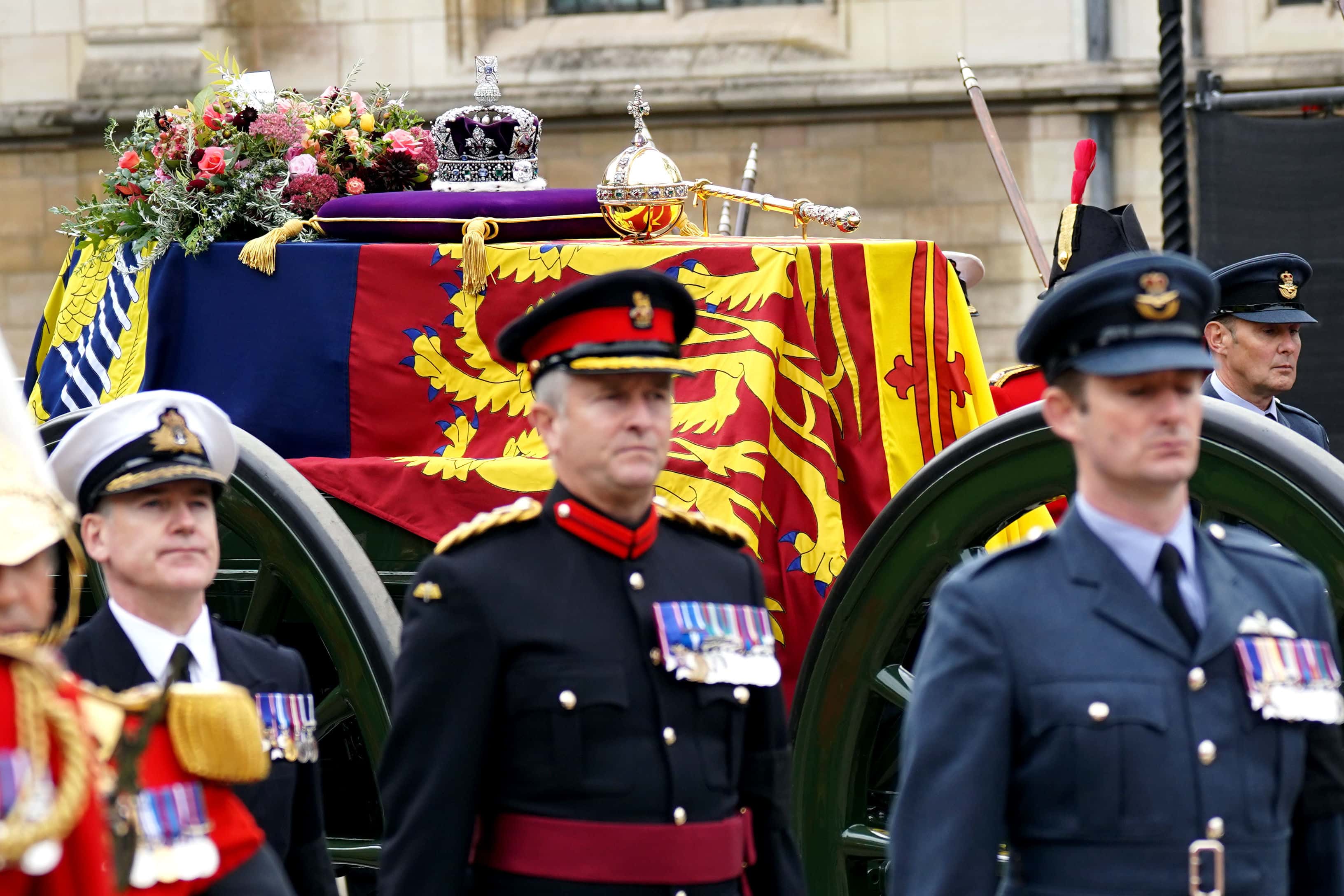 The State Gun Carriage carries the coffin of Queen Elizabeth II, draped in the Royal Standard with the Imperial State Crown and the Sovereign's orb and sceptre, as it leaves Westminster Hall for the State Funeral at Westminster Abbey on September 19, 2022 in London, England. Elizabeth Alexandra Mary Windsor was born in Bruton Street, Mayfair, London on 21 April 1926. She married Prince Philip in 1947 and ascended the throne of the United Kingdom and Commonwealth on 6 February 1952 after the death of her Father, King George VI. Queen Elizabeth II died at Balmoral Castle in Scotland on September 8, 2022, and is succeeded by her eldest son, King Charles III. (Photo by Yui Mok - WPA Pool/Getty Images)
