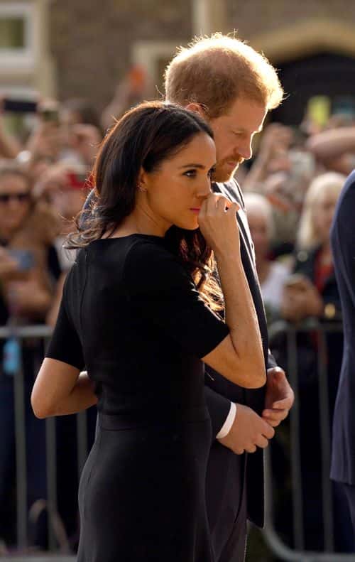 Prince Harry, Duke of Sussex, and Meghan, Duchess of Sussex view floral tributes left at Windsor Castle on September 10, 2022 in Windsor, England. Crowds have gathered and tributes left at the gates of Windsor Castle to Queen Elizabeth II, who died at Balmoral Castle on 8 September, 2022.