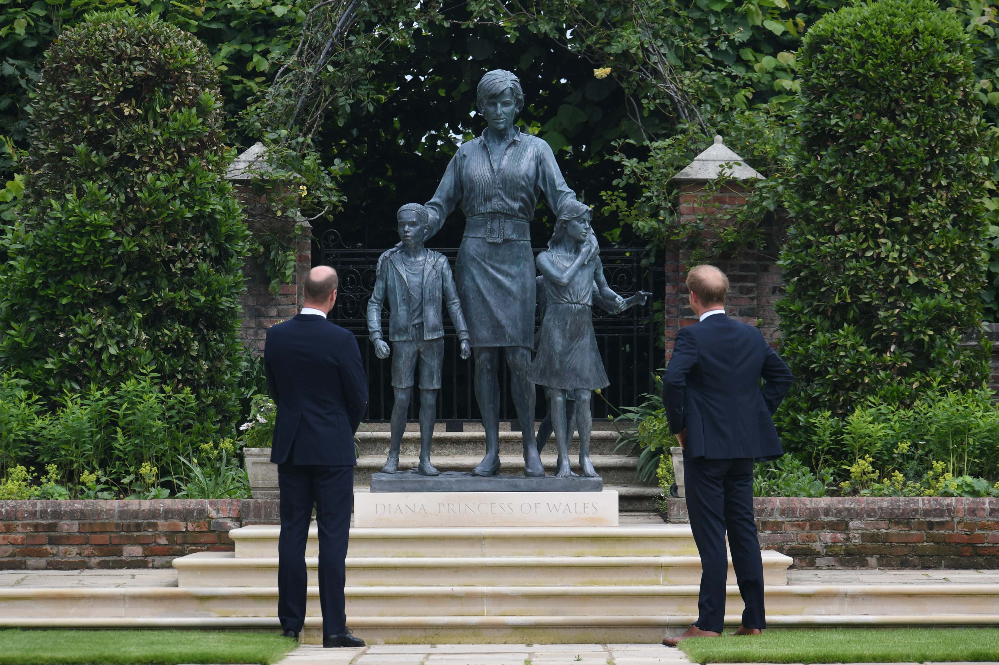 Prince William, Duke of Cambridge (left) and Prince Harry, Duke of Sussex look at a statue they commissioned of their mother Diana, Princess of Wales, in the Sunken Garden at Kensington Palace, on what would have been her 60th birthday on July 1, 2021 in London, England. Today would have been the 60th birthday of Princess Diana, who died in 1997. At a ceremony here today, her sons Prince William and Prince Harry, the Duke of Cambridge and the Duke of Sussex respectively, will unveil a statue in her memory.