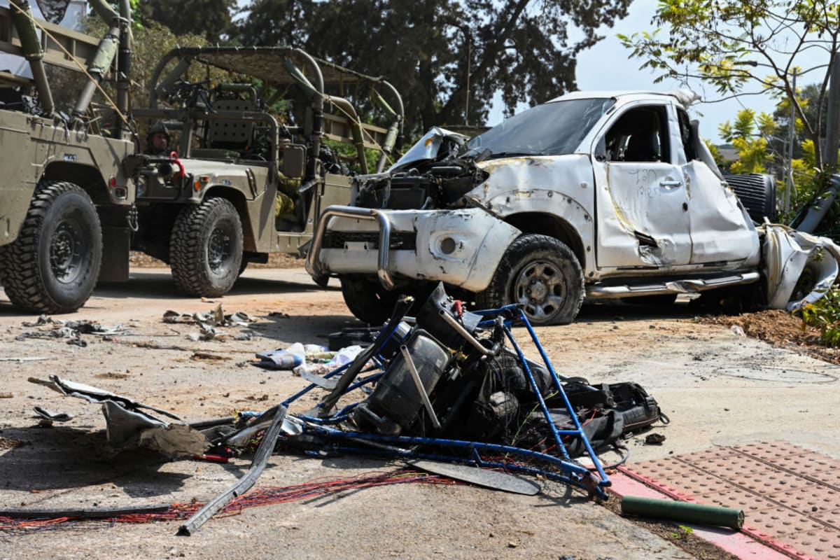 A motorbike used by Hamas militants lies destroyed near a car that was shot at in Saturday's attack by Hamas militants on this kibbutz near the border with Gaza, on October 10, 2023 in Kfar Aza, Israel. (Getty Image)