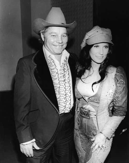 American country music singer and guitarist Loretta Lynn and her husband Oliver Lynn, Jr. (also known as Mooney) (1948 - 1996) at the Country & Western Music Awards, Hollywood, California, February 27, 1975. (Photo by Hulton Archive/Getty Images)