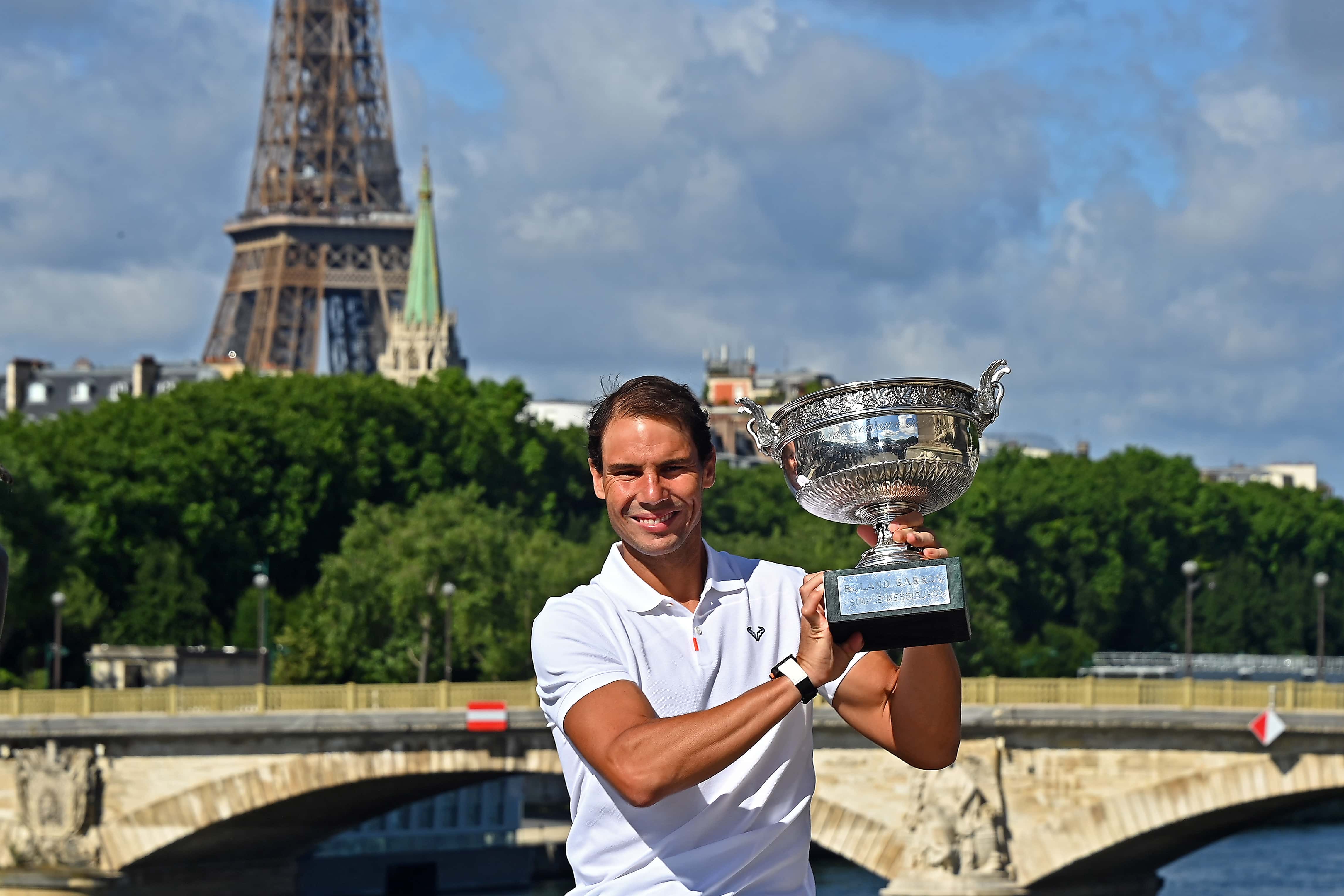 Rafael Nadal of Spain poses with the Musketeers trophy after winning his 14th Roland Garros Grand Chelem tournament on Alexander the 3rd bridge on June 06, 2022 in Paris, France.