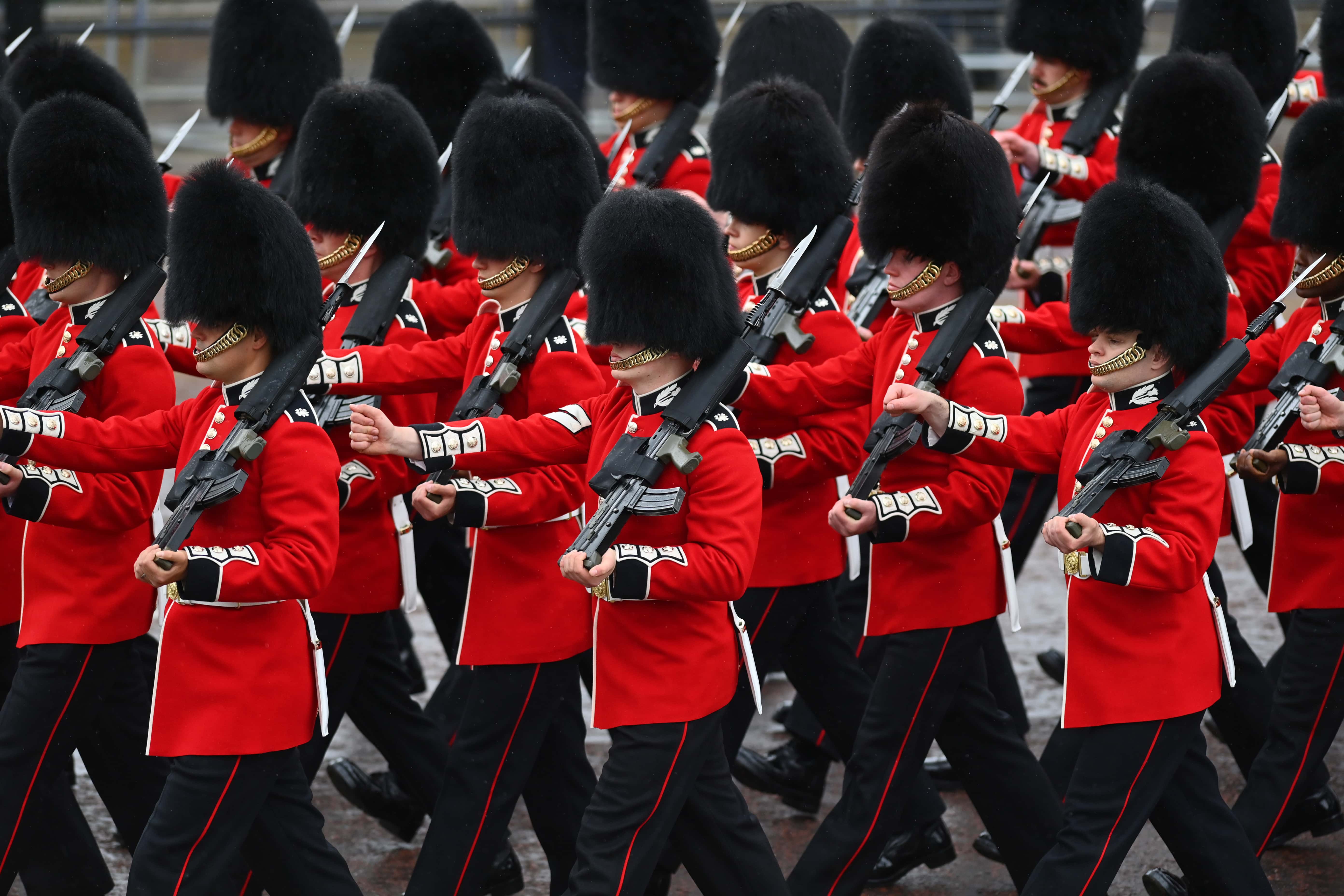 Coldstream Guards stand to attention ahead of the Coronation of King Charles III and Queen Camilla on May 06, 2023, in London, England. The Coronation of Charles III and his wife, Camilla, as King and Queen of the United Kingdom of Great Britain and Northern Ireland, and the other Commonwealth realms takes place at Westminster Abbey today. Charles acceded to the throne on 8 September 2022, upon the death of his mother, Elizabeth II. (Photo by Dan Mullan/Getty Images)