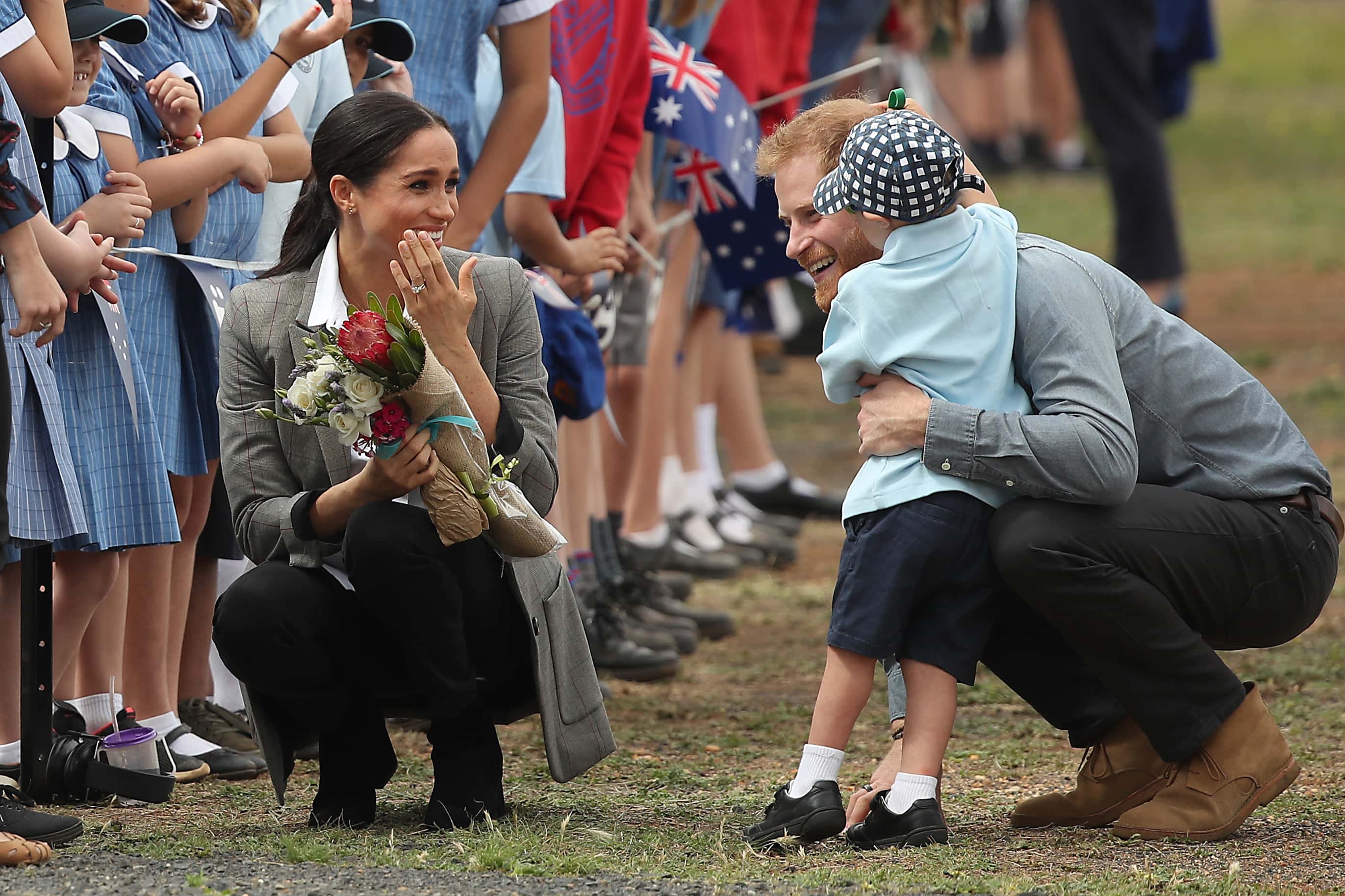 Prince Harry, Duke of Sussex and Meghan, Duchess of Sussex meet with local children as they arrive at Dubbo Airport on October 17, 2018 in Dubbo, Australia. The Duke and Duchess of Sussex are on their official 16-day Autumn tour visiting cities in Australia, Fiji, Tonga and New Zealand.