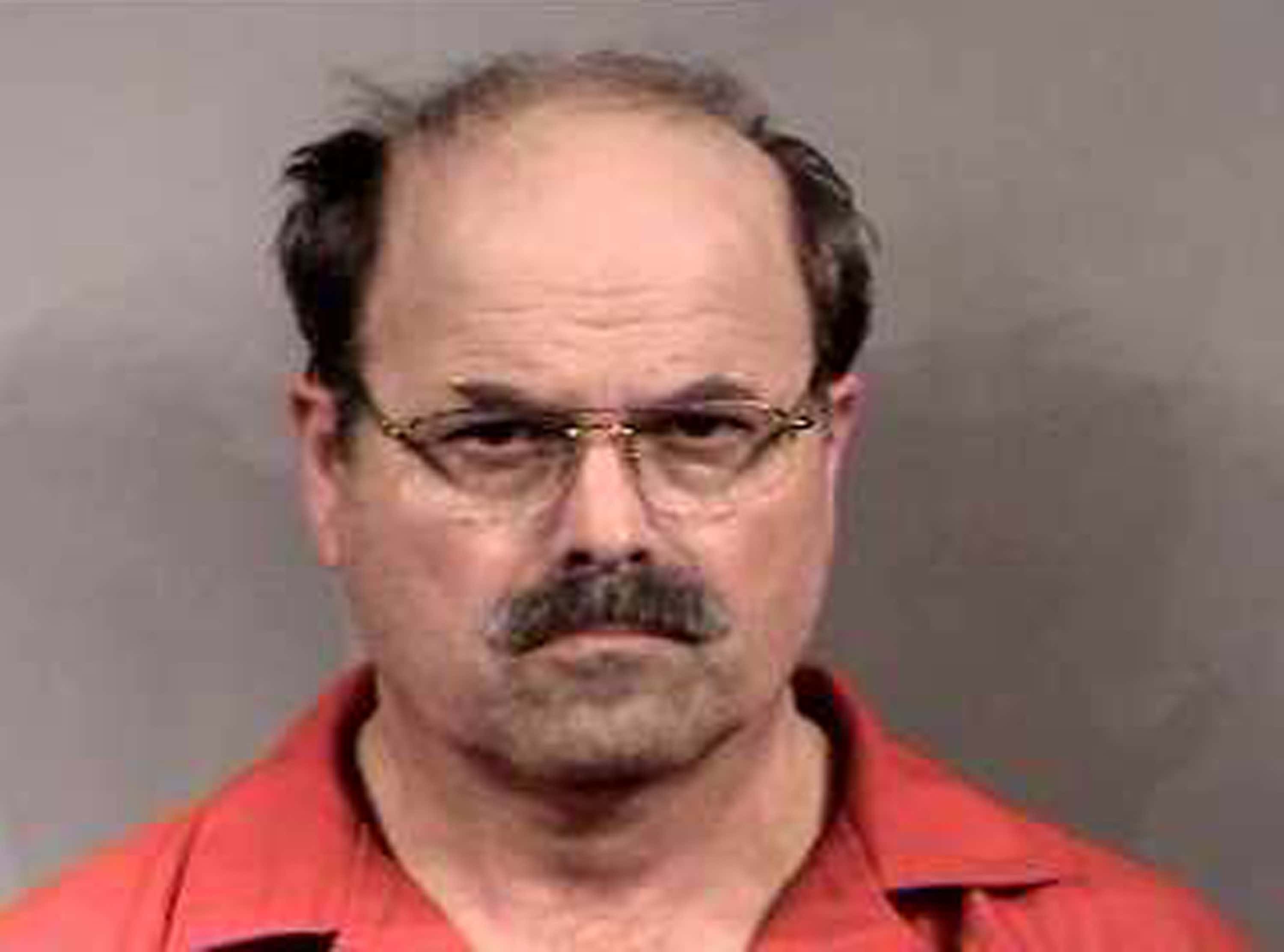 In this handout image provided by the Sedgwick County Sheriff's office, BTK murder suspect Dennis Rader stands for a mug shot released February 27, 2005 in Sedgwick County, Kansas. Rader is the suspect whom police have arrested on suspicion of first-degree murder in connection with the 10 deaths now tied to the serial killer known as BTK.