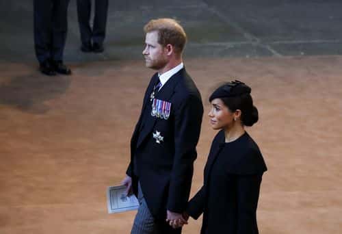 Prince Harry and Meghan, Duchess of Sussex walk as procession with the coffin of Britain's Queen Elizabeth arrives at Westminster Hall from Buckingham Palace for her lying in state on September 14, 2022 in London, United Kingdom. Queen Elizabeth II's coffin is taken in procession on a Gun Carriage of The King's Troop Royal Horse Artillery from Buckingham Palace to Westminster Hall where she will lay in state until the early morning of her funeral. Queen Elizabeth II died at Balmoral Castle in Scotland on September 8, 2022, and is succeeded by her eldest son, King Charles III.