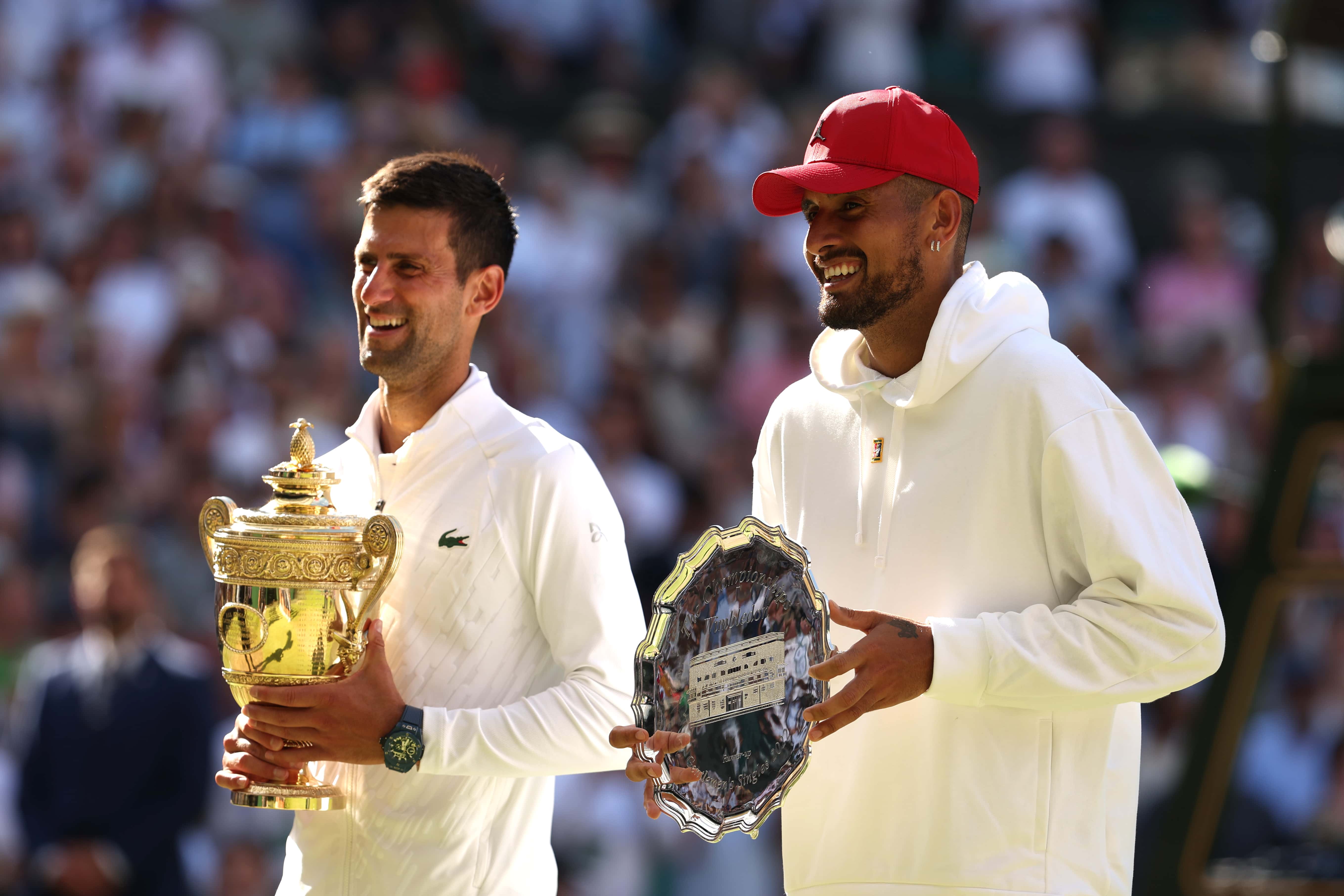 Winner Novak Djokovic of Serbia (R) and runner up Nick Kyrgios of Australia interact with their trophies following their Men's Singles Final match on day fourteen of The Championships Wimbledon 2022 at All England Lawn Tennis and Croquet Club on July 10, 2022 in London, England. (Photo by Julian Finney/Getty Images)