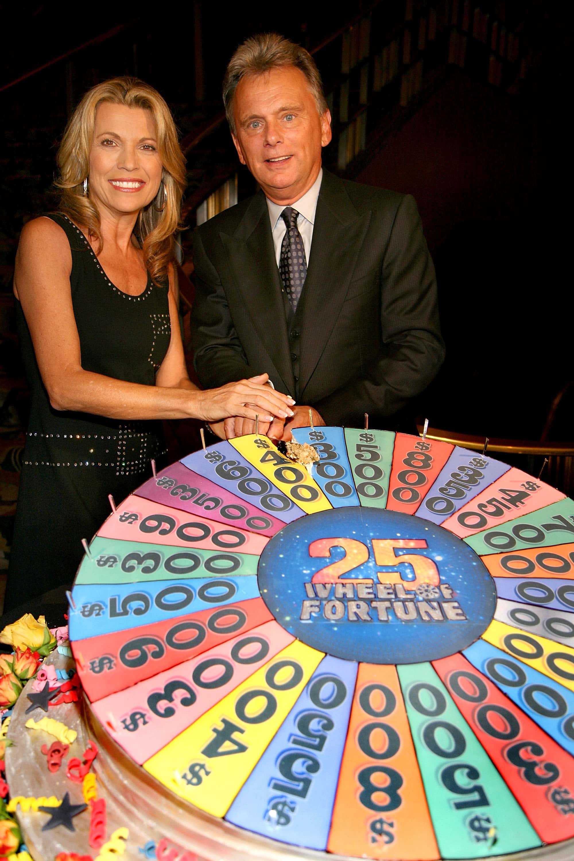 NEW YORK - SEPTEMBER 27:   Pat Sajak and model Vanna White cut the cake at the the 25th anniversary 