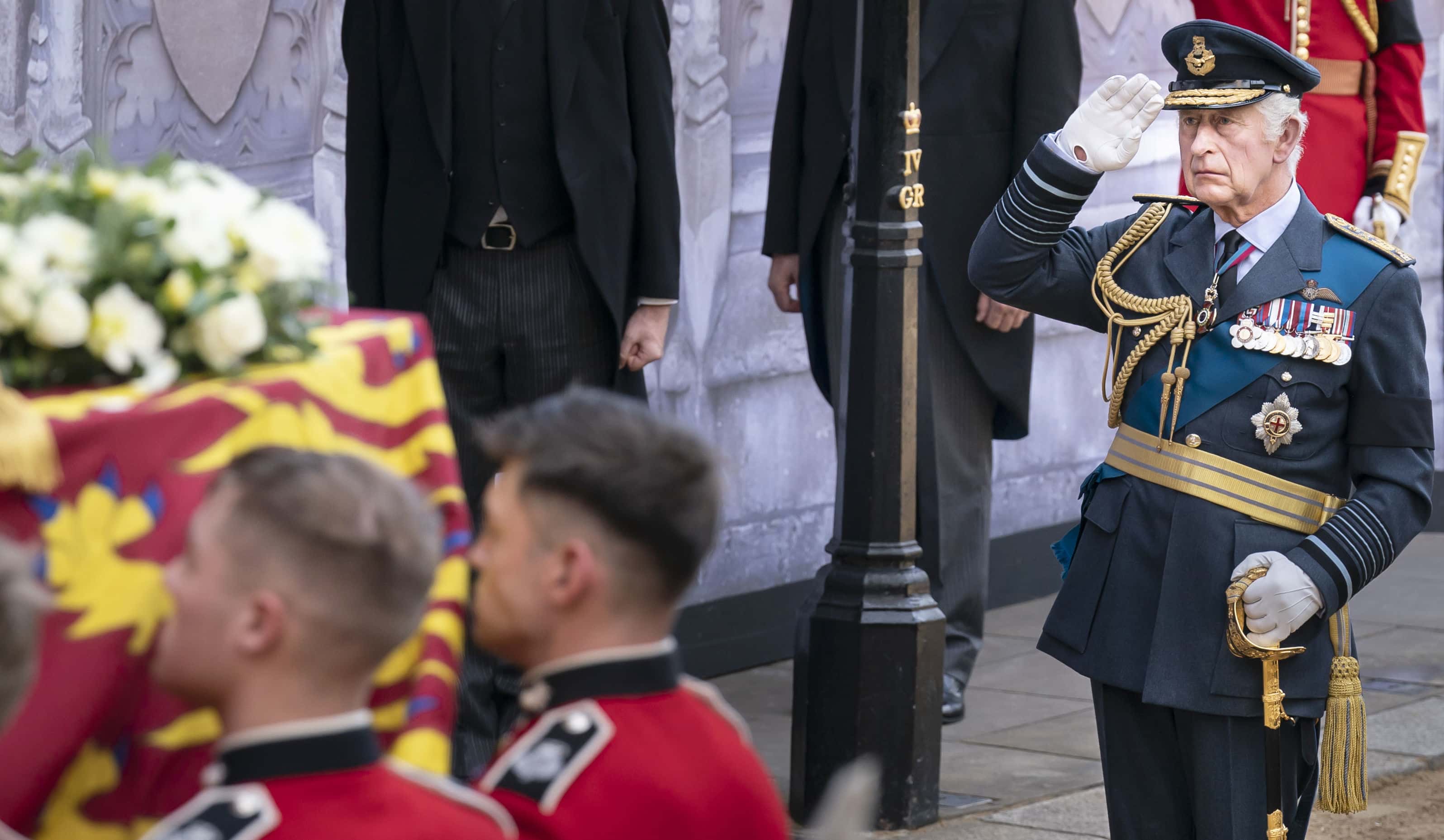 King Charles III, salutes as the bearer party carry the coffin of his mother, Queen Elizabeth II, into Westminster Hall, London, where it will lie in state ahead of her funeral on Monday, on September 14, 2022 in London, England. Queen Elizabeth II's coffin is taken in procession on a Gun Carriage of The King's Troop Royal Horse Artillery from Buckingham Palace to Westminster Hall where she will lay in state until the early morning of her funeral. Queen Elizabeth II died at Balmoral Castle in Scotland on September 8, 2022, and is succeeded by her eldest son, King Charles III. (Photo Danny Lawson - WPA Pool/Getty Images)