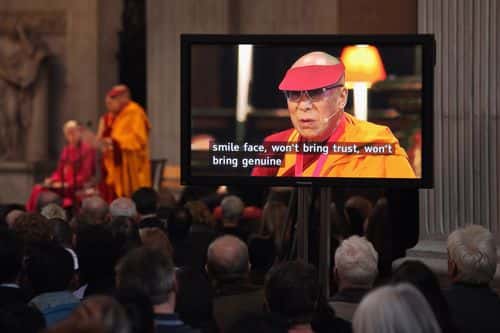 People watch a screen displaying subtitles as His Holiness the Dalai Lama addresses the audience in St Paul's Cathedral after receiving the 2012 Templeton Prize on May 14, 2012 in London, England. The exiled 76 year-old Buddhist Tibetan leader will receive the international prize worth 1.1 million GBP that honours people who