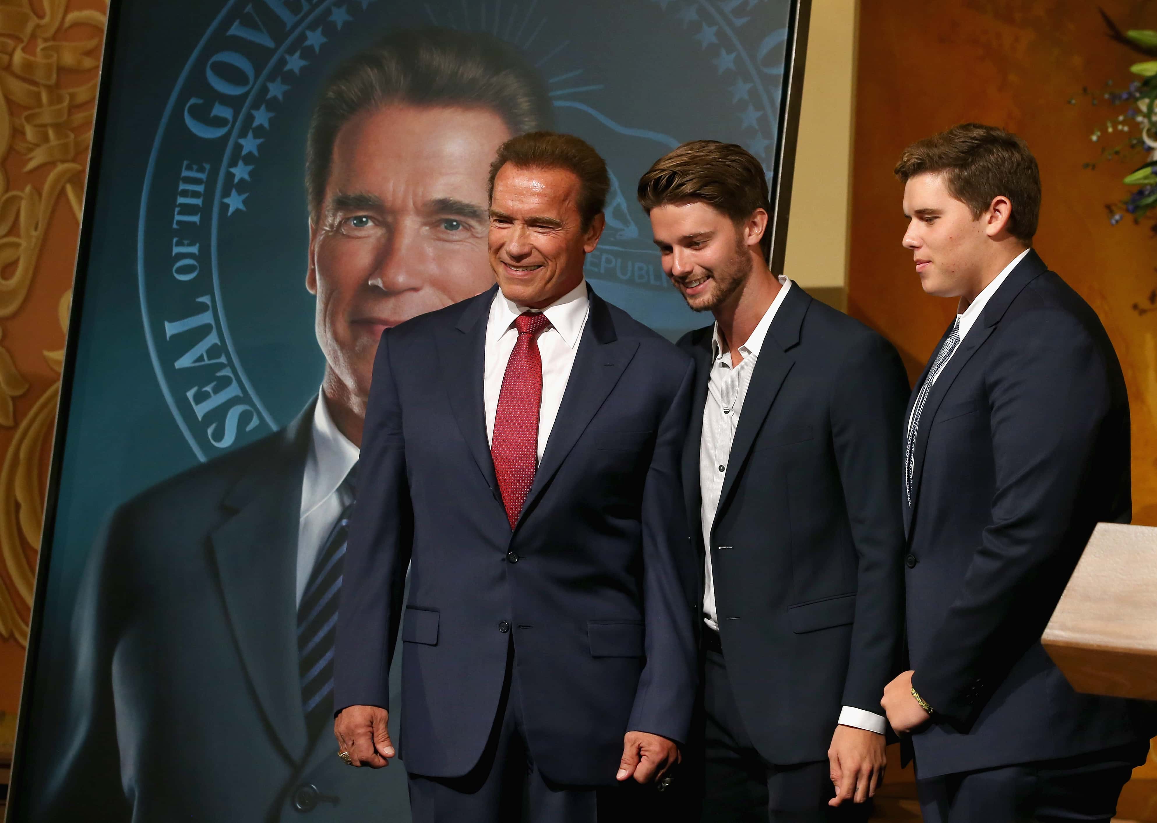 SACRAMENTO, CA - SEPTEMBER 08:  Former California Gov. Arnold Schwarzenegger poses with his sons Patrick (center) and Christopher  in front of his gubernatorial portrait at the unveiling in the Rotunda of the State Capitol September 8, 2014 in Sacramento, California.  (Photo by Justin Sullivan/Getty Images)