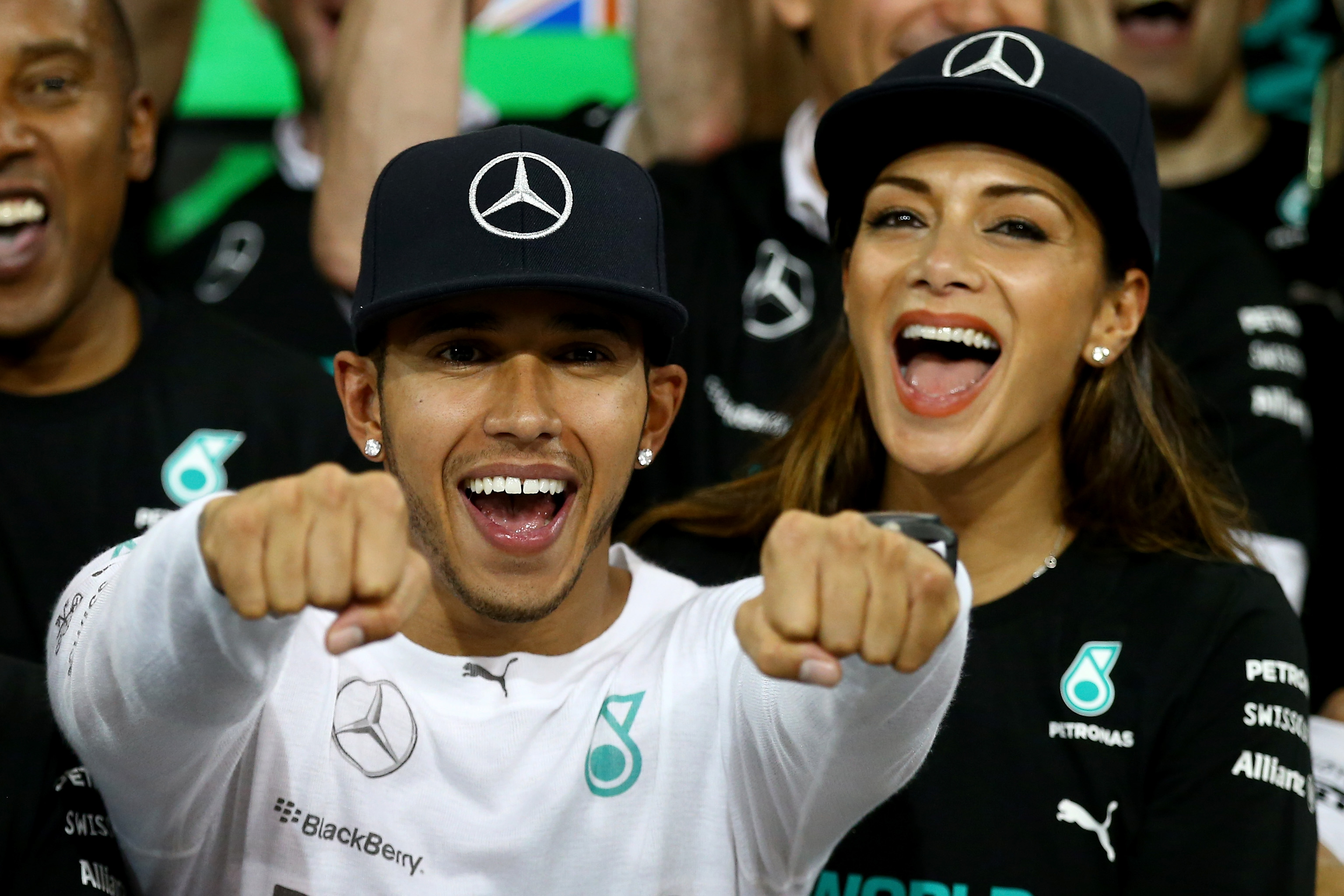 Lewis Hamilton of Great Britain and Mercedes GP celebrates with his team and Nicole Scherzinger after winning the World Championship after the Abu Dhabi Formula One Grand Prix at Yas Marina Circuit on November 23, 2014 in Abu Dhabi, United Arab Emirates.