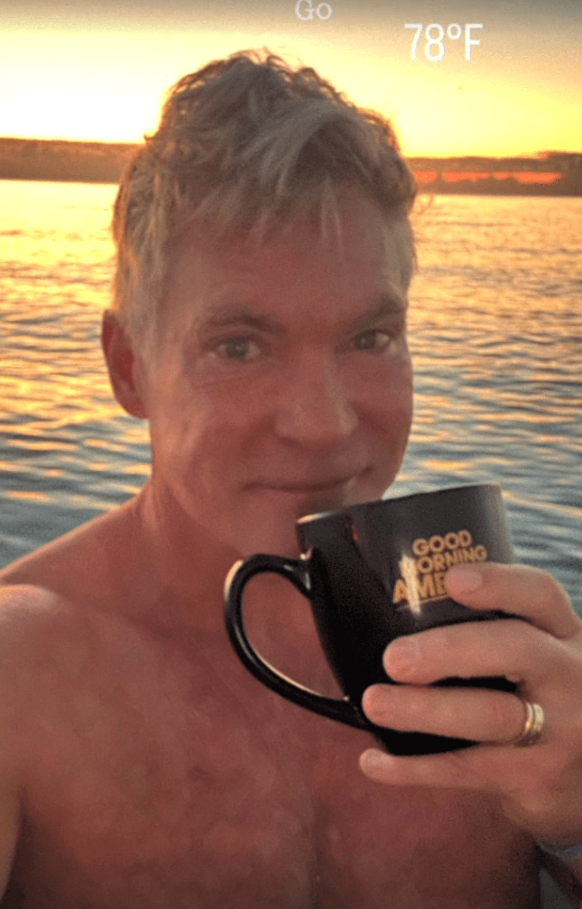 Sam Champion stood in front of the ocean sipping his morning coffee (@samchampion/Instagram)
