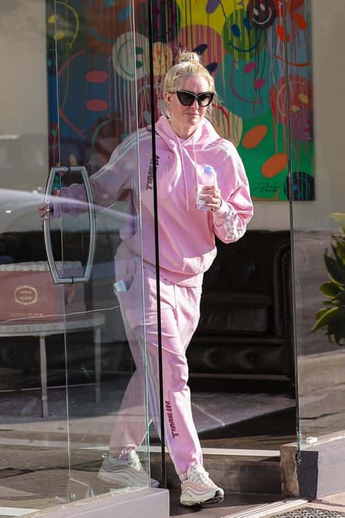 The media personality, who refers to herself as 'The Pretty Mess', added drama to her make-up-free look with a pair of oversized cat eye-shaped sunglasses. (Backgrid)