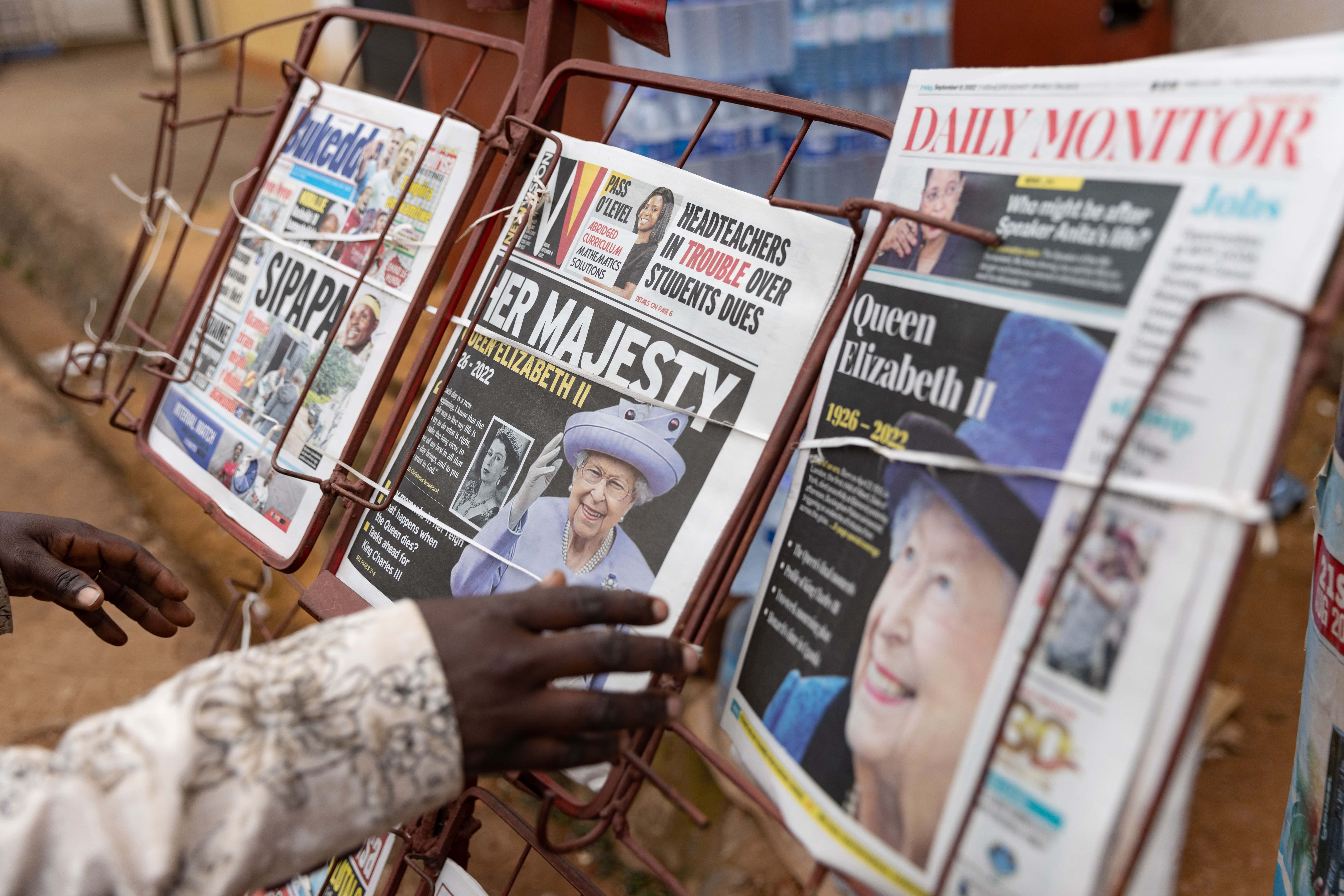 A man goes to buy a New Vision newspaper, with news of the death of Queen Elizabeth II on the front page, on September 09, 2022 in Entebbe, Uganda. Queen Elizabeth II, the UK's longest-serving monarch, has died at Balmoral aged 96, after reigning for 70 years. (Photo by Luke Dray/Getty Images)