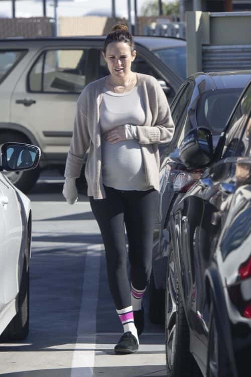 Rumer Willis cradles baby bump while leaving doctor's office. (Backgrid)