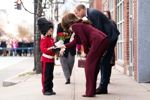 Britain's Prince William, Prince of Wales, and Catherine, Princess of Wales are presented with flowers by Henry Dynov-Teixeira, aged 8, dressed as a Guardsman, during a visit to the Greentown Labs in Somerville, to learn about climate innovations which are being incubated in Boston on December 1, 2022 in Boston, United States. Greentown Labs has nurtured a community of climate pioneers who are working to design and implement a more sustainable world. Founded by entrepreneurs, Greentown Labs brings together start-ups, corporates and investors to foster ingenuity and collaboration. Greentown is recognised as the largest climate technology start-up incubator in North America, having supported more than 500 companies since its founding that have collectively created more than 9,000 jobs and raised more than $4 billion in funding.