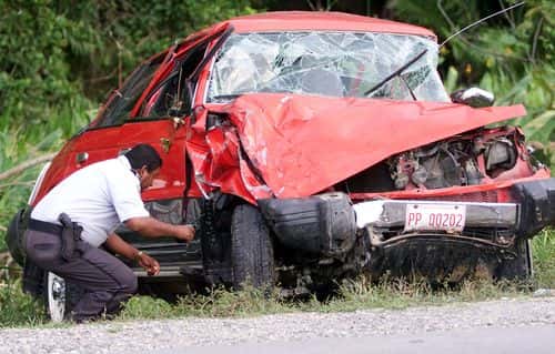 A Honduran policeman inspects the vehicle driven by singer Lisa Left Eye Lopes April 27, 2002 in La Ceiba, Honduras. Lopes, a member of the Hip Hop band 