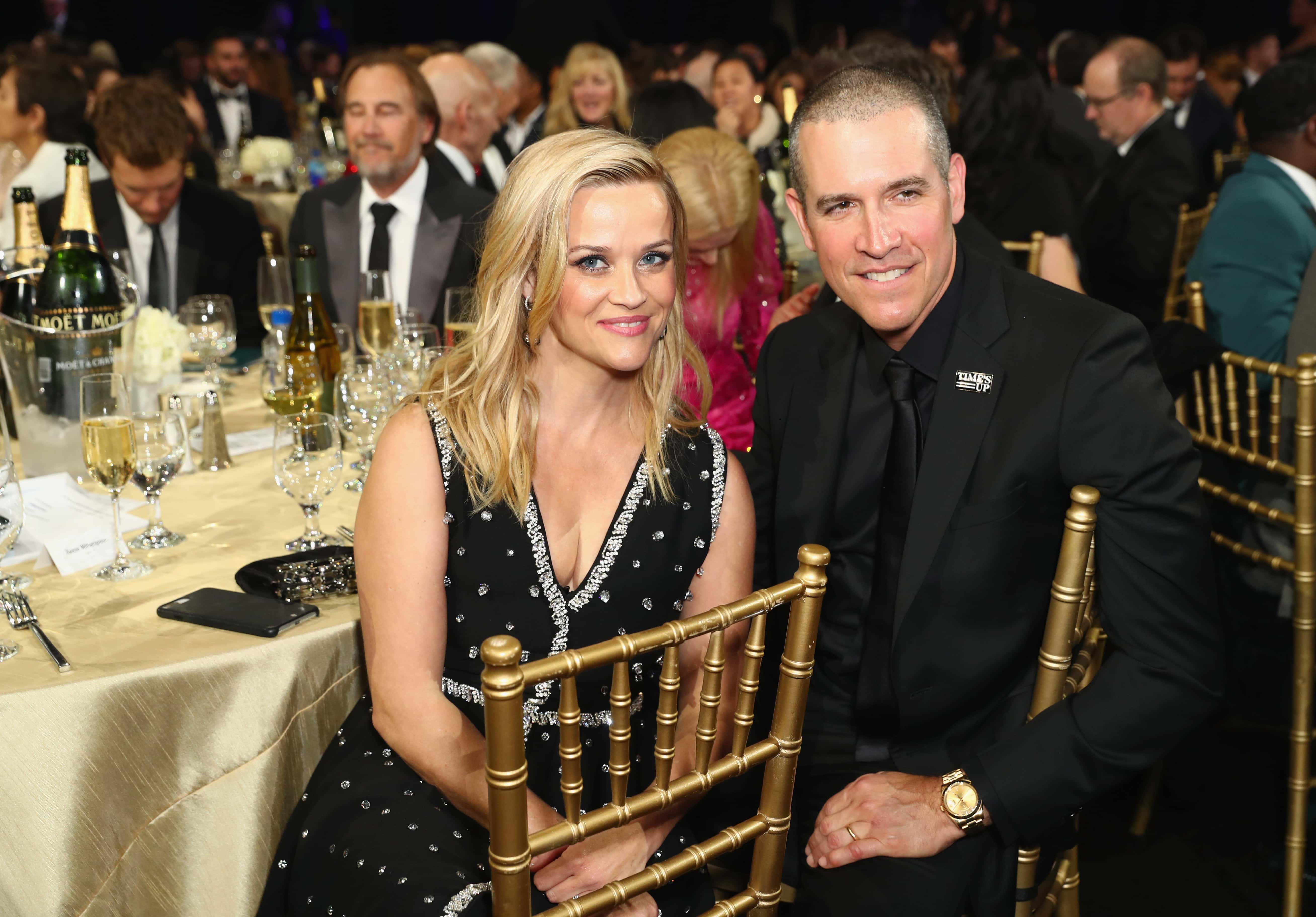 Actor Reese Witherspoon (L) and Jim Toth attend the 23rd Annual Critics' Choice Awards on January 11, 2018 in Santa Monica, California. (Photo by Joe Scarnici/Getty Images for FIJI Water)