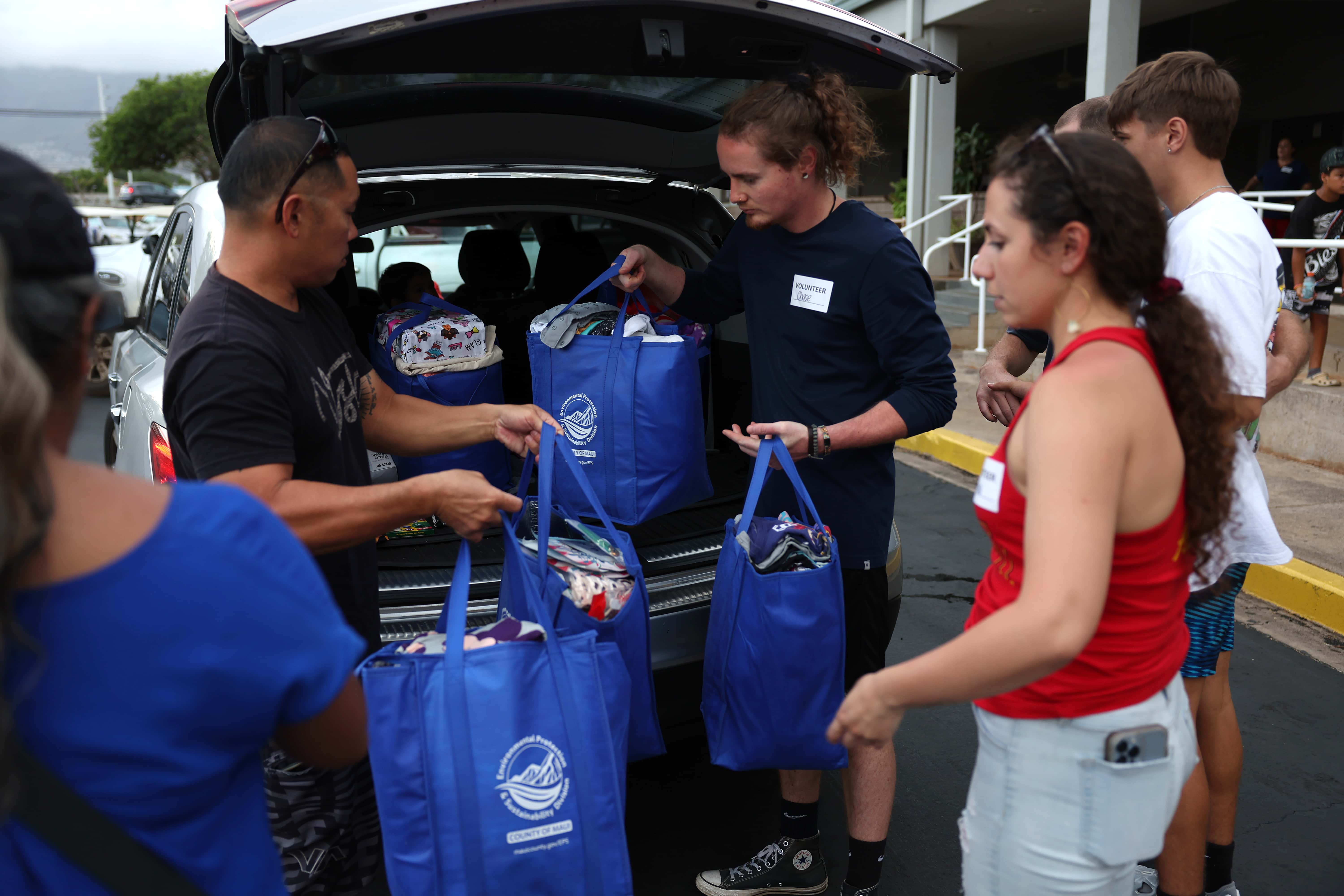 Volunteers with King's Cathedral Maui help unload a donation of supplies on August 10, 2023, in Kahului, Hawaii. Dozens of people were killed and thousands displaced after a wind-driven wildfire devastated the town of Lahaina on Tuesday. (Photo by Justin Sullivan/Getty Images)