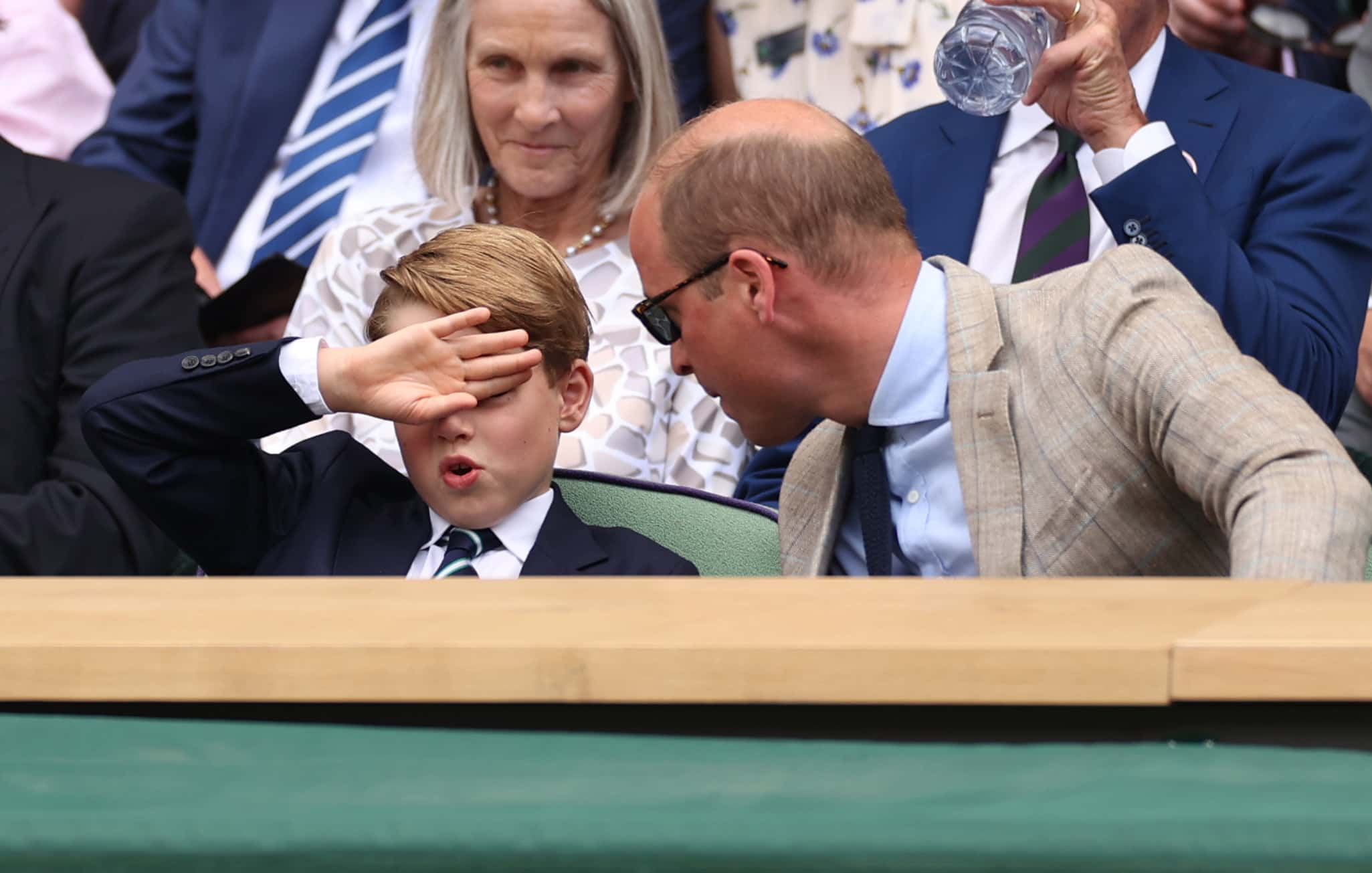 Prince William, Duke of Cambridge (R) and Prince George of Cambridge interact in the Royal Box watching Novak Djokovic of Serbia play Nick Kyrgios of Australia during their Men's Singles Final match on day fourteen of The Championships Wimbledon 2022 at All England Lawn Tennis and Croquet Club on July 10, 2022 in London, England.