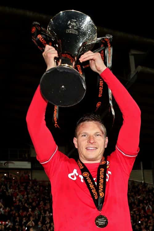 Paul Mullin of Wrexham celebrates with the Vanarama National League trophy as Wrexham win the Vanarama National League and are promoted to the English Football League after victory in the Vanarama National League match between Wrexham and Boreham Wood at Racecourse Ground on April 22, 2023 in Wrexham, Wales.