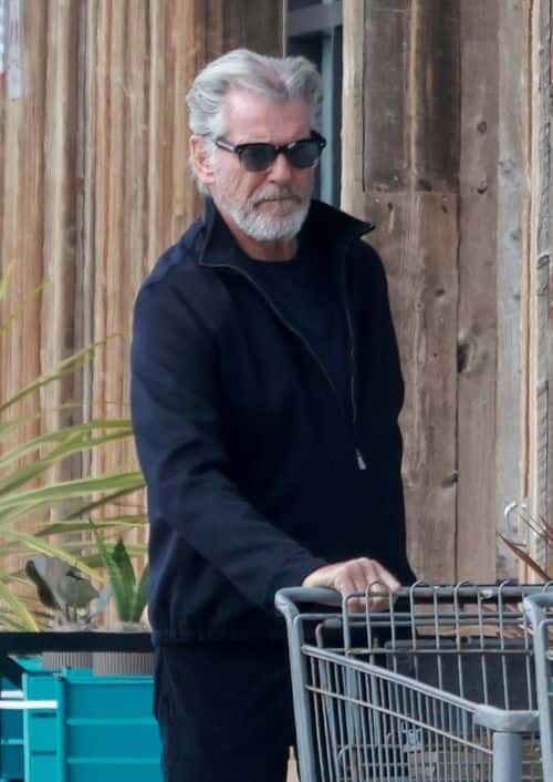 He appeared at ease as he cheerfully returned the trolley to its stop and carried the bag full of goods to his car (Backgrid)