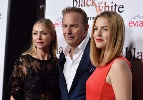 Actor Kevin Costner (C), his wife Christine Baumgartner (L) and daughter actress Lily Costner (R) arrive at the premiere of Relativity Media's 