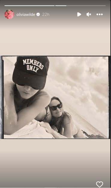 The House star, 39, wore a thin black bikini and was unable to contain her laughter as her friend threw sand on top of her (@oliviawilde, Instagram)