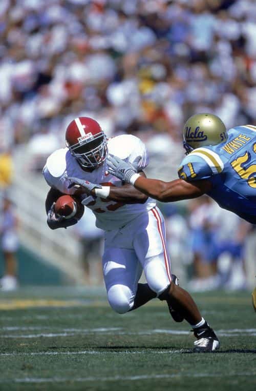 2 Sep 2000:  Ahmaad Galloway #29 of the Alabama Crimson Tide runs with the ball while Tony White #51 reaches to tackle him during the game against the UCLA Bruins at the Rose Bowl in Pasadena, California. The Bruins defeated the Crimson Tide 24-35. Mandatory Credit: Jon Ferrey  /Allsport