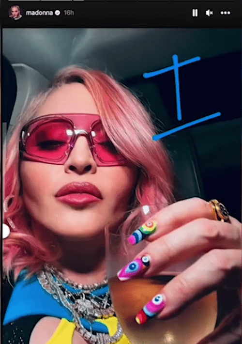 The singer was seen wearing shades, some colorful nails and holding a drink in her hand as she made the bizarre confession (Madonna/Instagram story)