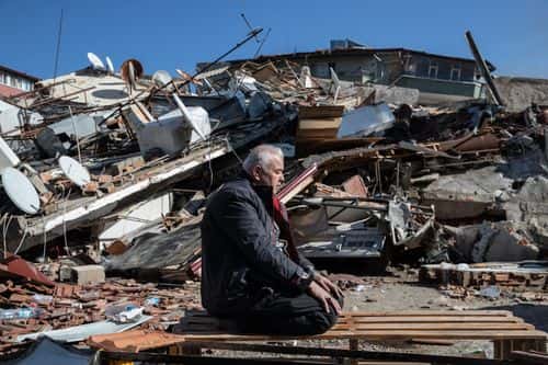A man prays in front of a collapsed building on February 08, 2023 in Hatay, Turkey. A 7.8-magnitude earthquake hit near Gaziantep, Turkey, in the early hours of Monday, followed by another 7.5-magnitude tremor just after midday. The quakes caused widespread destruction in southern Turkey and northern Syria and were felt in nearby countries.