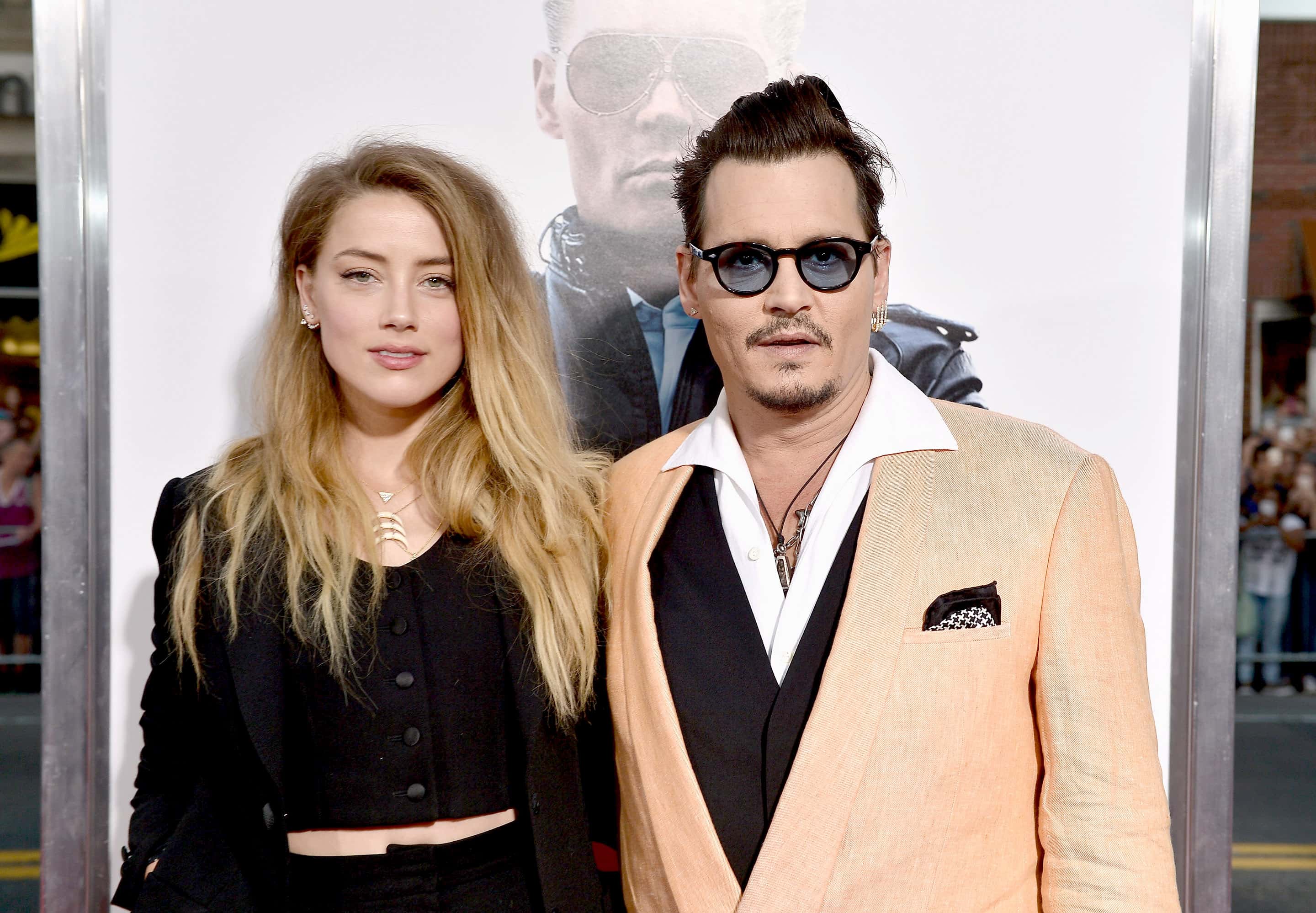 Actors Amber Heard (L) and Johnny Depp attend the 