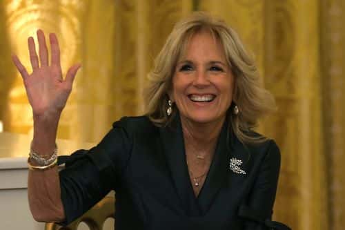 U.S. first lady Jill Biden waves to members of the press prior to President Joe Biden's Christmas address in the East Room of the White House on December 22, 2022 in Washington, DC. President Biden gave the address to wish Americans a happy holiday.