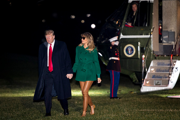 U.S. President Donald Trump and First Lady Melania Trump make their way across the South Lawn of the White House after returning on Marine One from their surprise trip to Al Asad Air Base in Iraq to visit troops, on December 27, 2018, in Washington, DC. (Getty Images)