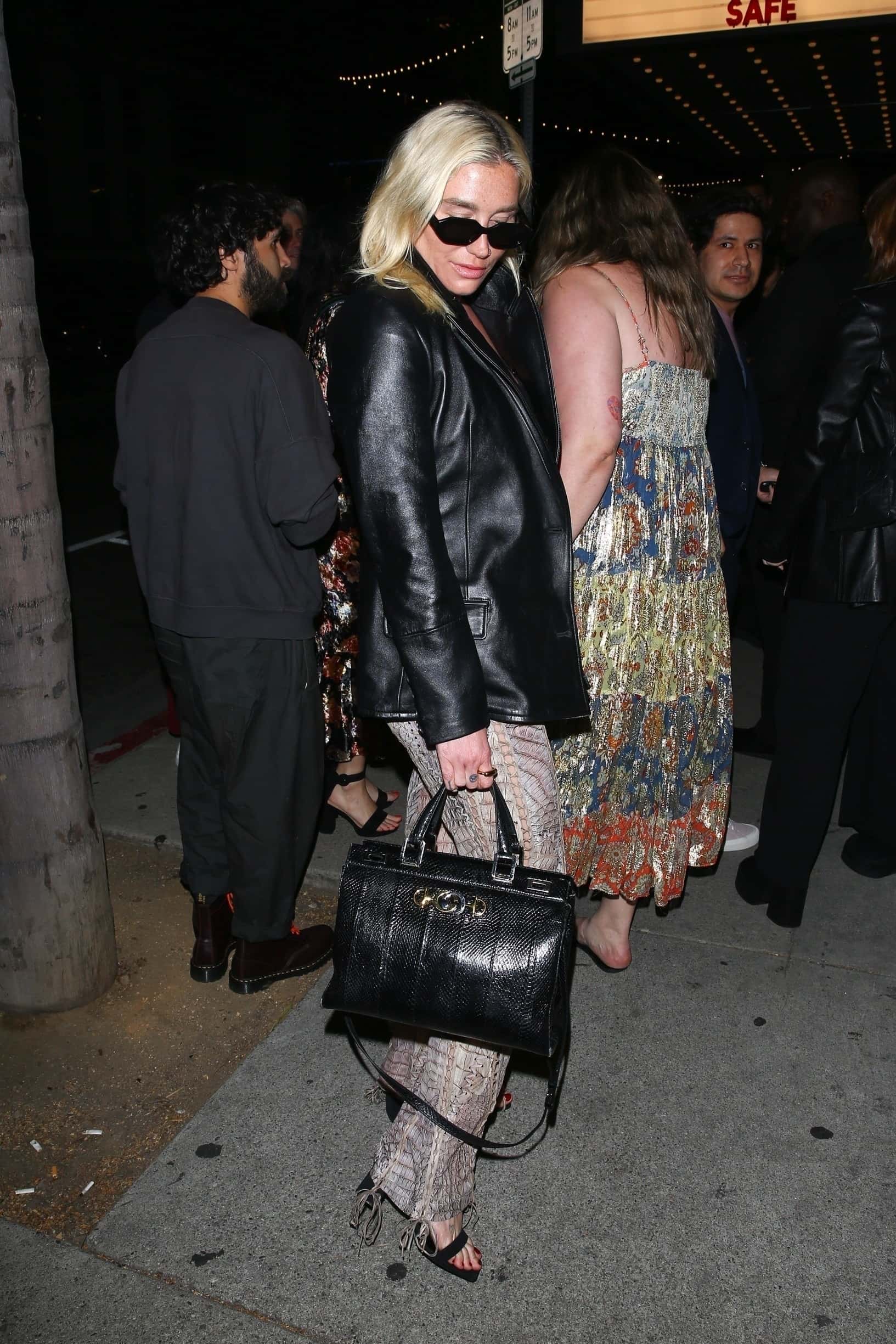 Sporting sunglasses and carrying a black Gucci handbag, the Timber songstress accessorized her look while toting her essentials around (Backgrid)